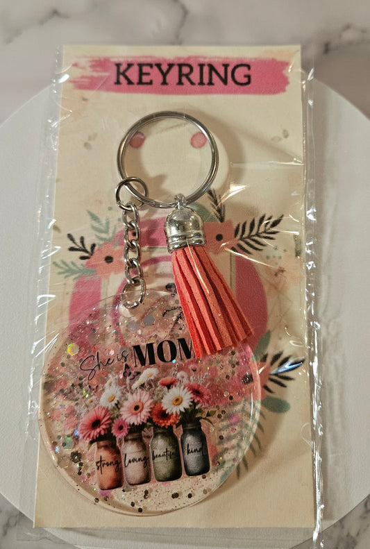 She is Mom- Strong, loving, beautiful and kind Keyring